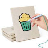 Hand punching one of the Snack Time Treats mini canvases