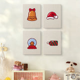 The four Snow Globe Christmas mini canvases on a wall above a shelf