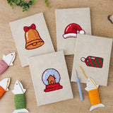 The four finished Snow Globe Christmas mini canvases laid out on a table