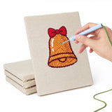 Hand punching one of the Snow Globe Christmas mini canvases