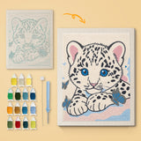 Snow Leopard Cub canvas before and after punching, with the threads and tools