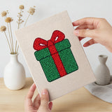 Hand holding a finished Snowman and Bauble mini canvas