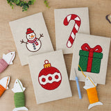 The four finished Snowman and Bauble mini canvases laid out on a table