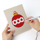 Punching a Snowman and Bauble mini canvas with the punch needle