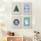 The four Snowman and Wreath mini canvases on a wall above a shelf