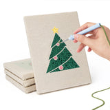 Hand punching one of the Snowman and Wreath mini canvases