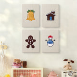 The four Snowy Cabin mini canvases on a wall above a shelf