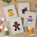 The four finished Snowy Cabin mini canvases laid out on a table