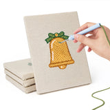 Hand punching one of the Snowy Cabin mini canvases