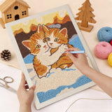 Punching the Snowy Ginger Cuddle design with the punch needle