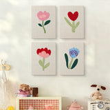 The four Soft Tulip Stems mini canvases on a wall above a shelf
