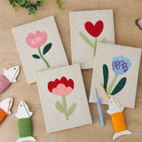 The four finished Soft Tulip Stems mini canvases laid out on a table