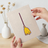 Hand holding a finished Spider and Broom mini canvas