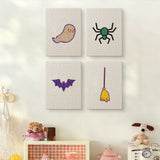 The four Spider and Broom mini canvases on a wall above a shelf