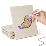 Hand punching one of the Spider and Broom mini canvases