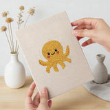Hand holding a finished Starfish and Octopus mini canvas