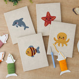 The four finished Starfish and Octopus mini canvases laid out on a table