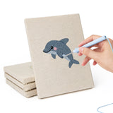 Hand punching one of the Starfish and Octopus mini canvases