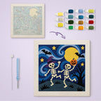Starry Skeleton Dance canvas before and after punching, with the threads and tools