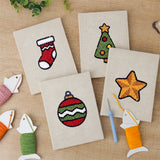 The four finished Stocking and Star mini canvases laid out on a table