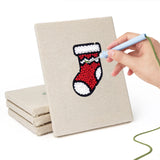 Hand punching one of the Stocking and Star mini canvases