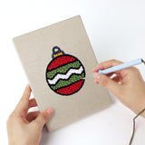 Punching a Stocking and Star mini canvas with the punch needle