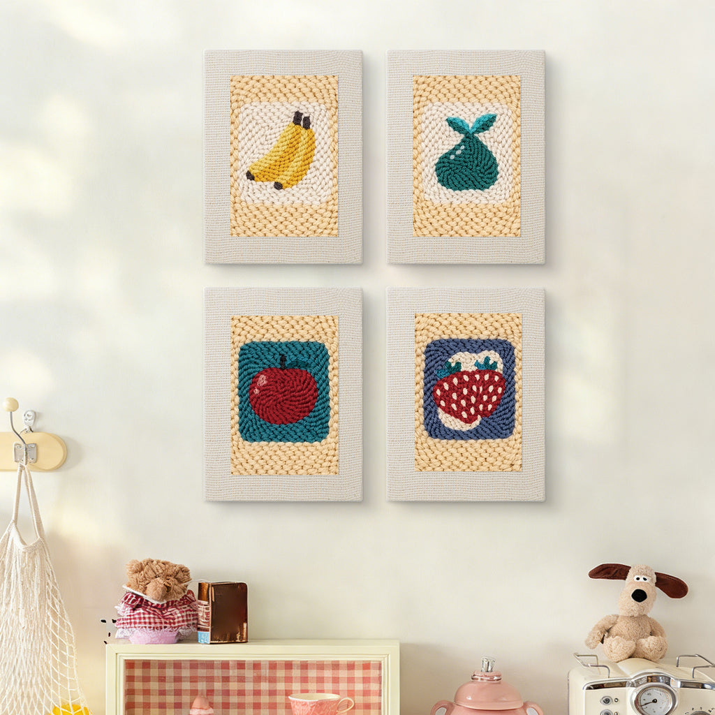 The four Strawberry and Bananas mini canvases on a wall above a shelf
