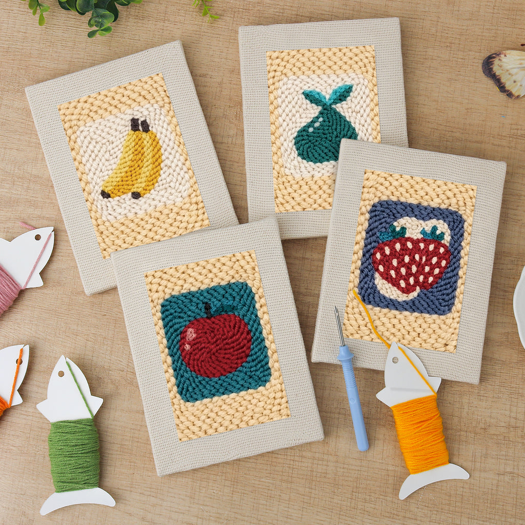 The four finished Strawberry and Bananas mini canvases laid out on a table
