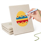 Hand punching one of the Striped Easter Eggs mini canvases