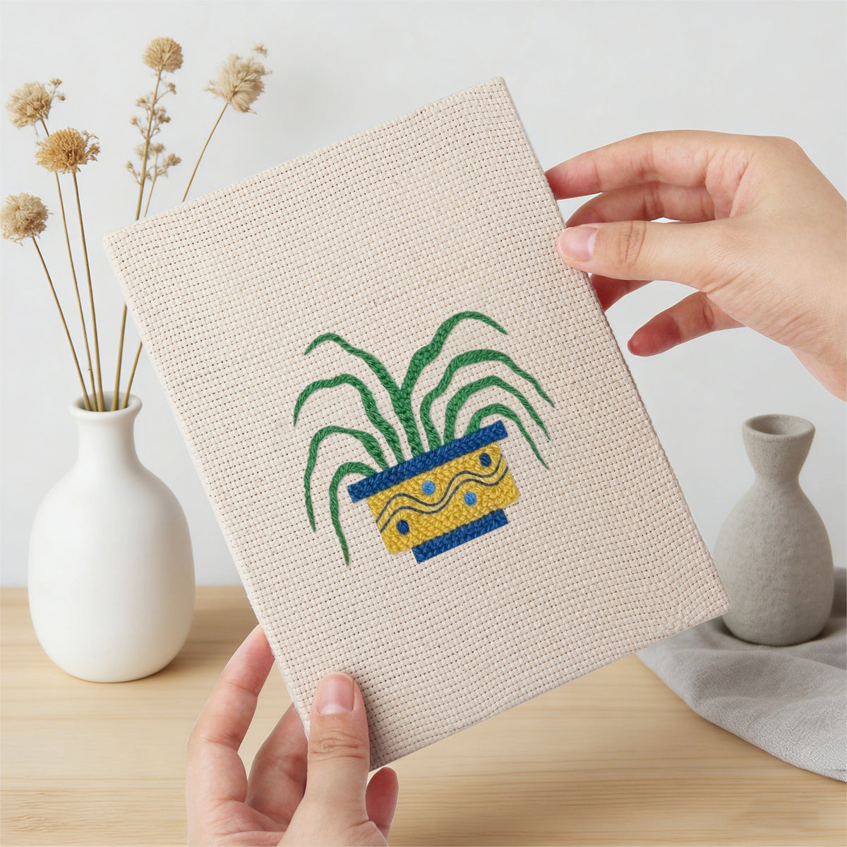 Hand holding a finished Striped Pot Plants mini canvas