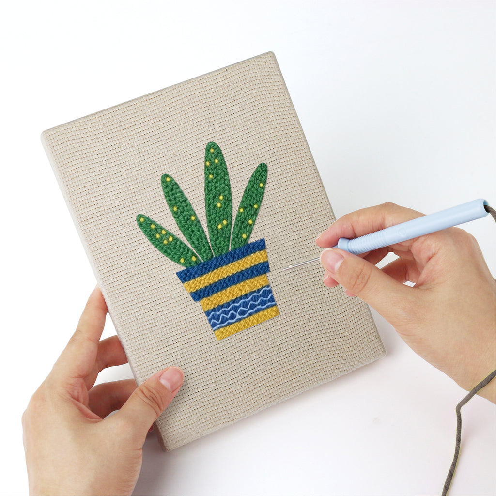 Punching a Striped Pot Plants mini canvas with the punch needle