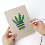 Punching a Striped Pot Plants mini canvas with the punch needle