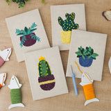 The four finished Succulent Shelf mini canvases laid out on a table