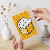 Hand holding a finished Sugar Cube Donut mini canvas