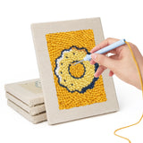 Hand punching one of the Sugar Cube Donut mini canvases