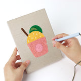 Punching a Summer Sips mini canvas with the punch needle