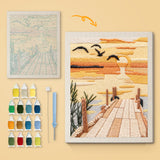 Sundown Pier canvas before and after punching, with the threads and tools
