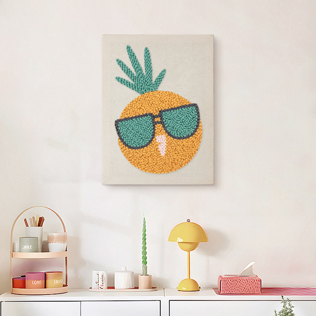 Finished Sunglasses Pineapple punch needle canvas on a wall