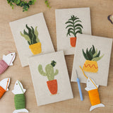 The four finished Sunny Pot Houseplants mini canvases laid out on a table