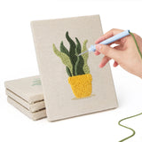 Hand punching one of the Sunny Pot Houseplants mini canvases