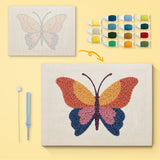 Sunset Butterfly canvas before and after punching, with the threads and tools