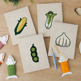The four finished Sweet Corn Harvest mini canvases laid out on a table