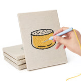 Hand punching one of the Sweet Dango Treats mini canvases