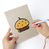 Punching a Sweet Dango Treats mini canvas with the punch needle