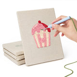 Hand punching one of the Sweetheart Charms mini canvases