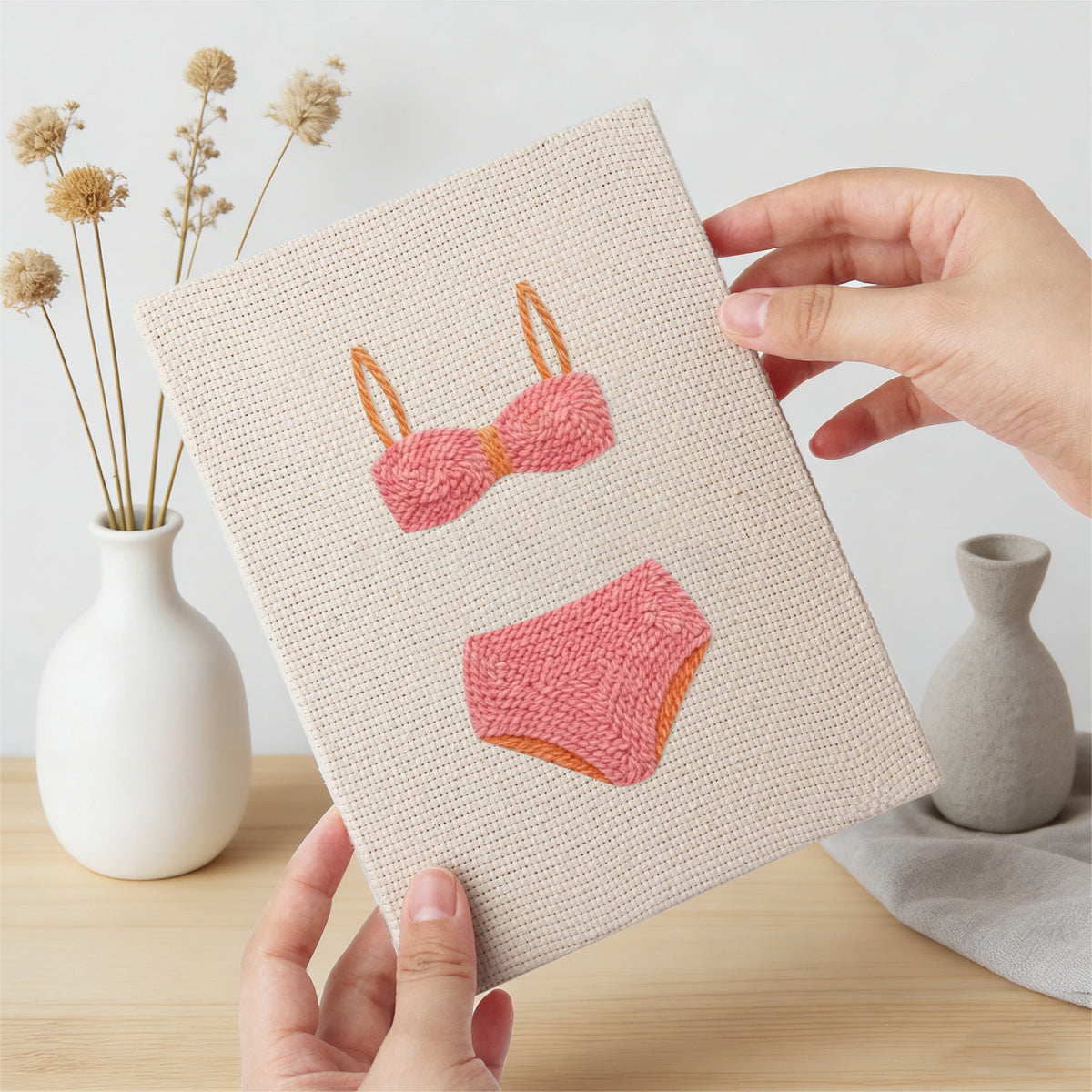 Hand holding a finished Swimsuit Season mini canvas