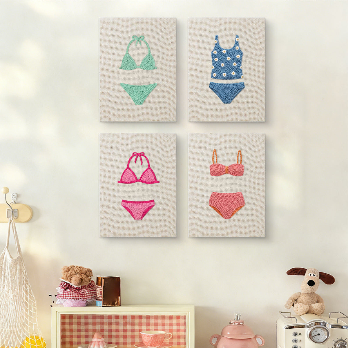 The four Swimsuit Season mini canvases on a wall above a shelf