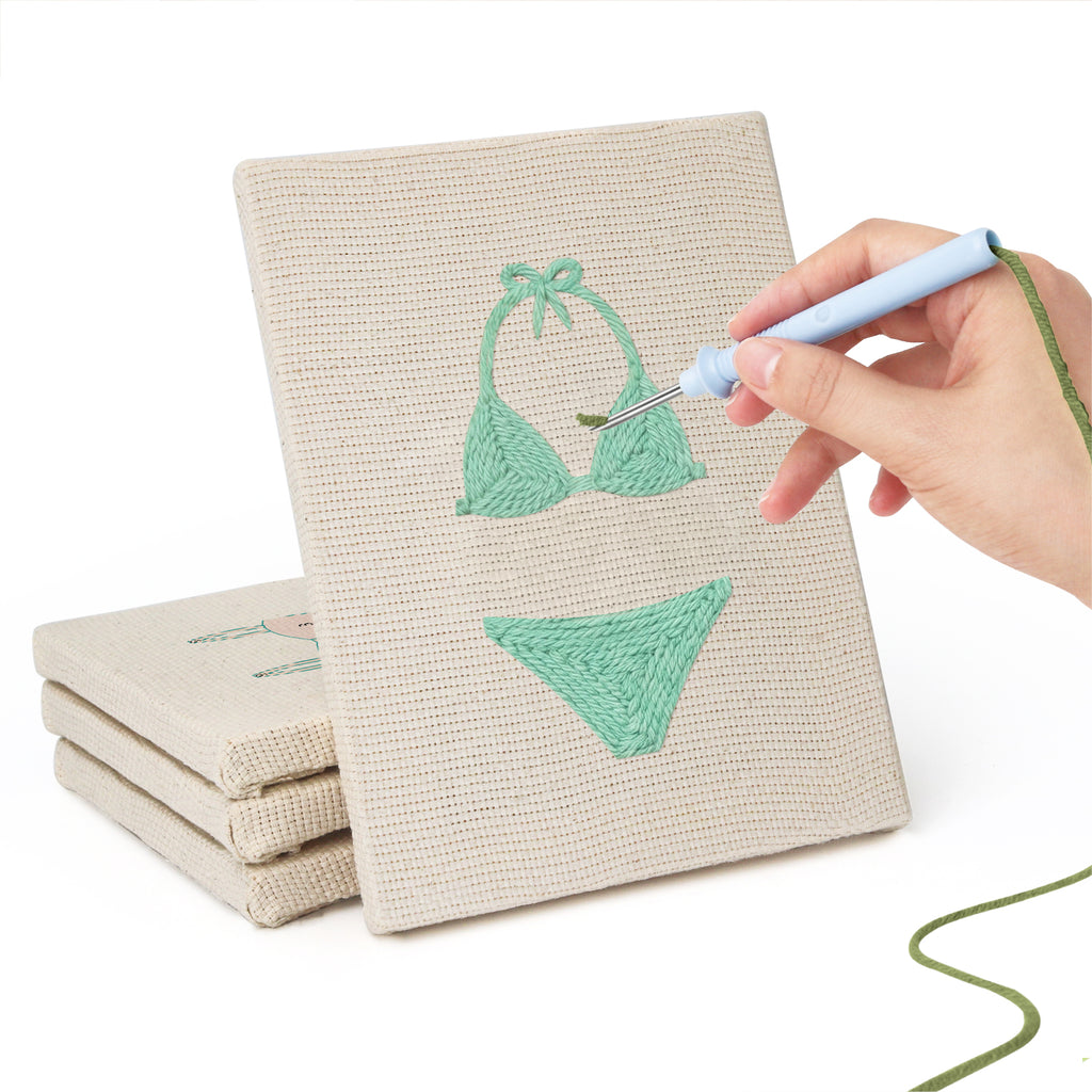 Hand punching one of the Swimsuit Season mini canvases