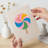 Hand holding a finished Swirl Lollipops mini canvas