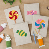 The four finished Swirl Lollipops mini canvases laid out on a table